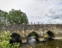 Runners on historic stone bridge
