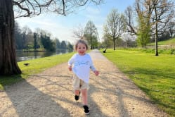 Child running through the lakeside walk route